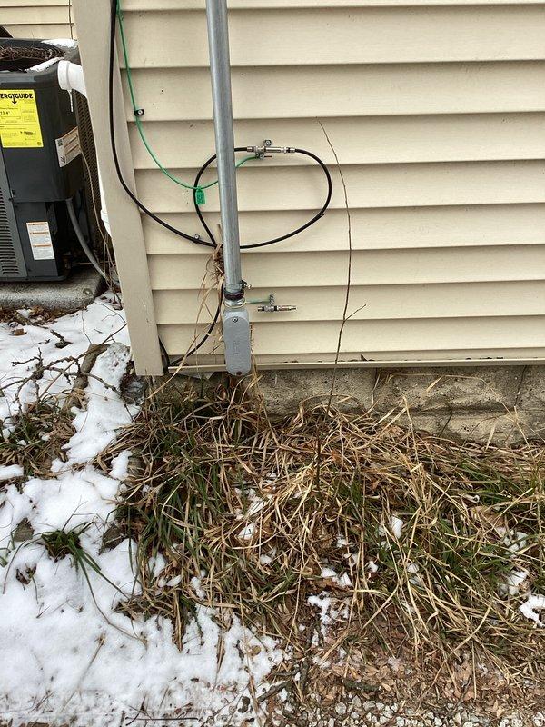 Performed Electrical Club Inspection of residential panel and exterior service connection. Inspected Square D breaker panel containing multiple 15A and 20A circuits with appropriate wiring and ground connections. Examined exterior service entrance, conduit, and junction box mounted on vinyl siding adjacent to HVAC equipment, confirming proper installation despite winter conditions.