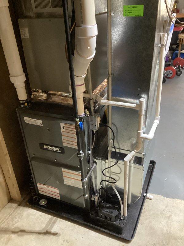 Successfully completed furnace installation in basement utility area, installing new Energy brand furnace unit with proper PVC ventilation system and ductwork connections. System was mounted on platform with all electrical connections properly secured, and new air filter was provided to customer.