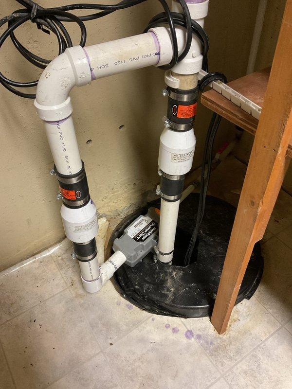 Diagnosed sump pump system making continuous banging noise after recent replacement. Inspected installation including PVC discharge piping, check valve, and electrical connections. Adjusted pump position within basin and secured loose fittings to eliminate noise issue; system now operating quietly with proper discharge flow.