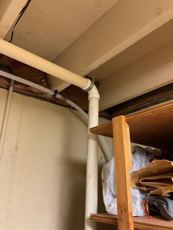 Diagnosed sump pump system making continuous banging noise after recent replacement. Inspected installation including PVC discharge piping, check valve, and electrical connections. Adjusted pump position within basin and secured loose fittings to eliminate noise issue; system now operating quietly with proper discharge flow.