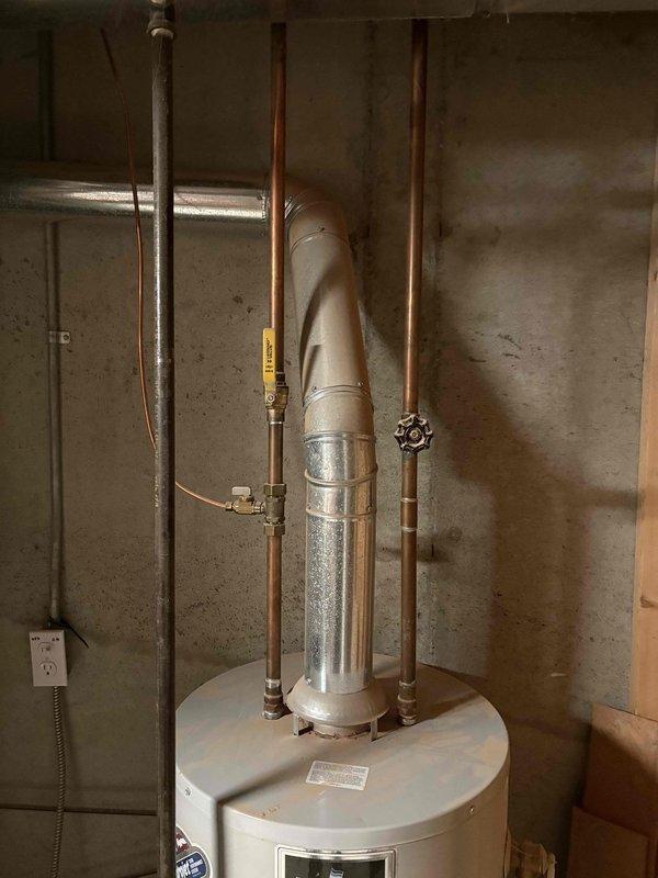 Responded to service call for 14-year-old Bradford water heater with complaint of very little hot water. Upon inspection, found significant sediment buildup restricting heat transfer efficiency. Flushed system to remove accumulated sediment and verified proper venting configuration, restoring normal hot water supply and function.