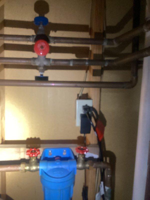 Successfully repaired pinhole leak in basement copper pipe near whole house filtration system. Replaced worn valves on the whole house filter unit to ensure proper function and prevent future leakage. System was pressure tested after repair to confirm integrity of the plumbing network.