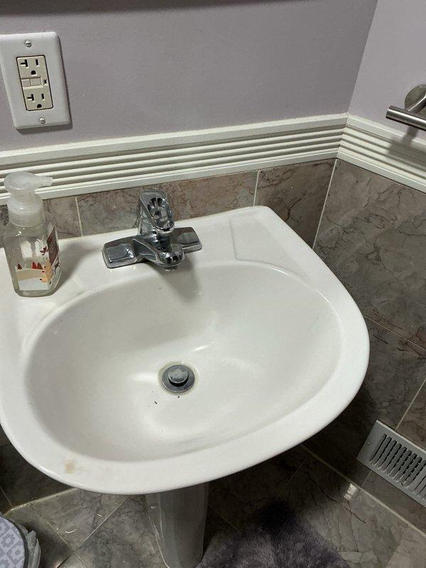 Responded to call regarding plumbing fixture maintenance. Serviced wall-mounted shutoff valve with connected PVC drainage system in bathroom. Inspected supply lines and connections at pedestal sink for proper function and verified no leaks present in the system.