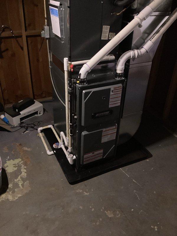 Successfully completed installation of new furnace in basement utility area. Unit was properly mounted on platform with all required PVC ventilation/drainage connections established and connected to existing ductwork. System was tested and verified operational with all appropriate warning labels affixed to equipment.