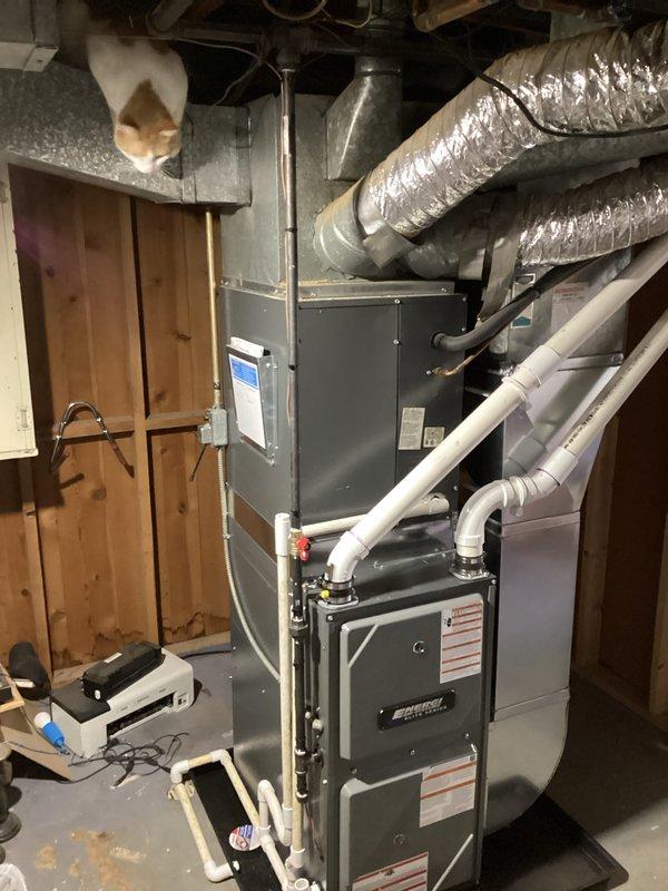 Successfully completed installation of new furnace in basement utility area. Unit was properly mounted on platform with all required PVC ventilation/drainage connections established and connected to existing ductwork. System was tested and verified operational with all appropriate warning labels affixed to equipment.