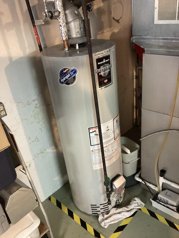 Conducted water heater replacement estimate for 12-year-old leaking Bradford White unit. Documented existing installation in utility room, noting pressure relief valve, piping connections, and surrounding HVAC components. Customer was informed of available replacement options including standard, hybrid, and tankless models with applicable promotional discounts.