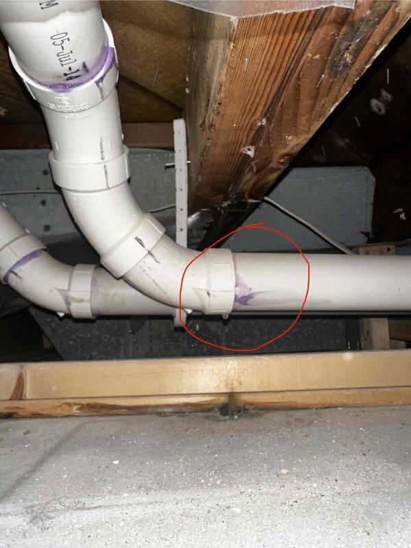 Performed annual maintenance on 11-year-old RUUD furnace. Accessed system through ceiling panel for inspection. Identified and documented plumbing issue with PVC pipe joint (highlighted in photo) that requires attention. System was manufactured in 2023 and is operating without humidity control issues.