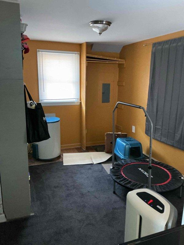 Performed site assessment for water heater and water softener estimate. Inspected existing utility access point in floor containing aged plumbing components. Evaluated installation space requirements in yellow-walled room with consideration for proper ventilation and access requirements. Documented current conditions with photos for accurate system specification and quote preparation.