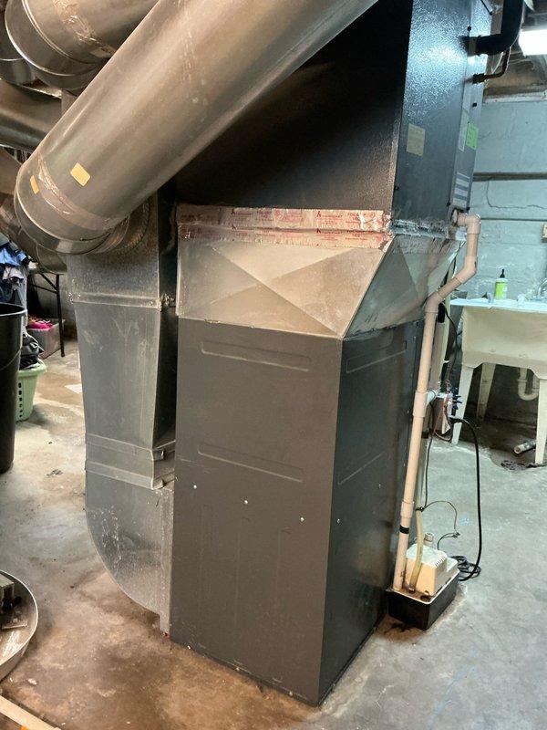 Performed estimate assessment on AC unit that sustained impact damage from falling ice. Visual inspection of the existing HVAC system revealed a damaged outdoor condenser unit requiring replacement. Documented the current installation configuration including furnace connections, ductwork, and drainage systems to ensure proper sizing for replacement equipment.