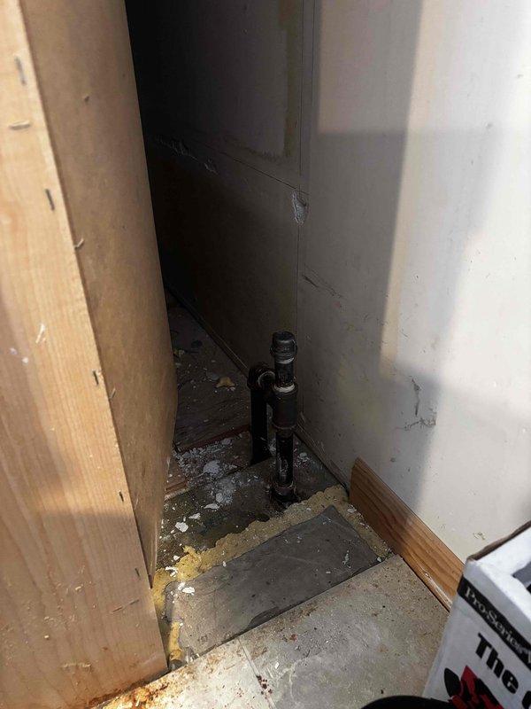 Successfully capped off gas line from stove in an unfinished renovation area. Accessed black gas pipe protruding from floor at wall corner junction, and properly sealed connection to ensure safety compliance.