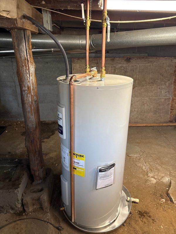 Successfully completed installation of a Bradford White 40-gallon electric water heater (240V/208V) in utility area. Unit was properly secured with copper supply lines connected to top ports using brass fittings, and installed on a metal drain pan for leak protection. All connections were verified and system tested for proper operation according to manufacturer specifications.
