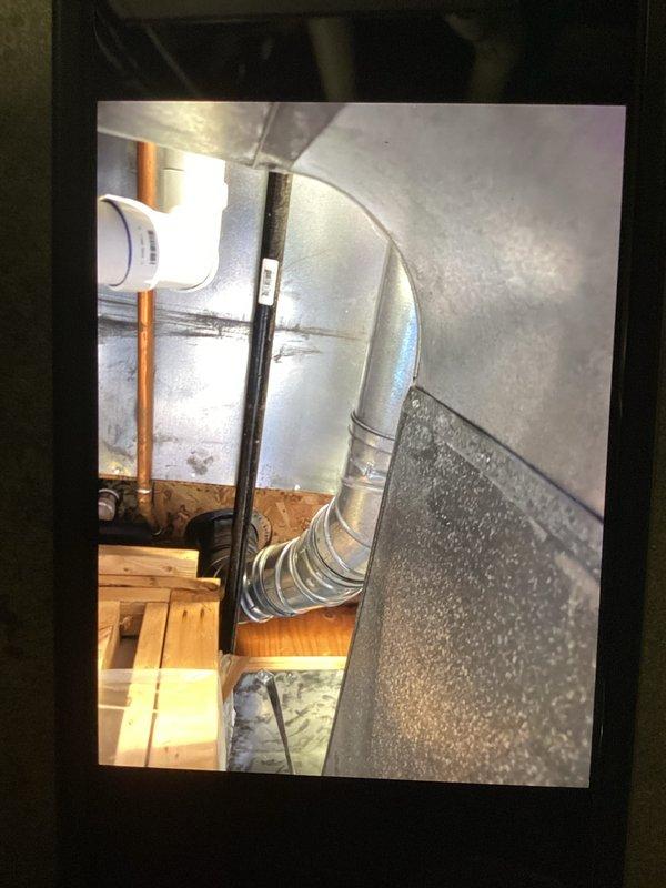 Conducted a water heater inspection for a 10-year-old Bradford White unit with reported insufficient hot water output. Examined the existing installation, ductwork, and ventilation system, documenting the condition of metal piping, connections, and surrounding structural elements. Photos taken of the installation for documentation purposes.