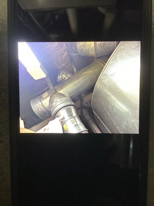 Conducted a water heater inspection for a 10-year-old Bradford White unit with reported insufficient hot water output. Examined the existing installation, ductwork, and ventilation system, documenting the condition of metal piping, connections, and surrounding structural elements. Photos taken of the installation for documentation purposes.