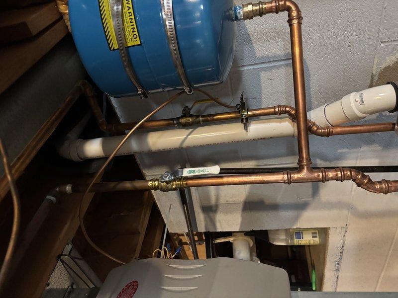 Performed quoted repair on 17-year-old Carrier furnace, replacing inducer and adding insulation to protect exhaust from floor joists. Inspected plumbing system with expansion tank and water heater installation, confirming proper connections and functionality of copper and PVC piping components.