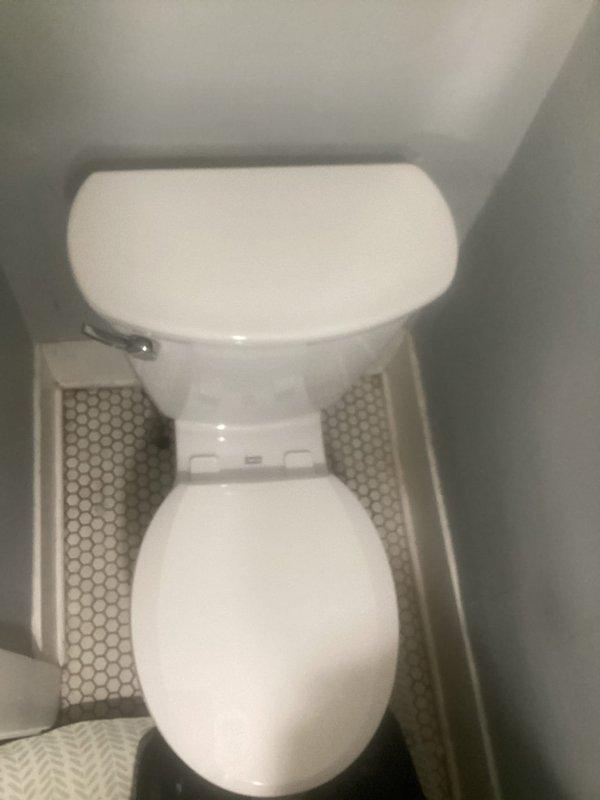Successfully completed quoted toilet replacement in residential bathroom. Installed new standard white toilet with oval seat and chrome flush lever. Properly positioned unit on hexagonal mosaic tile flooring with appropriate sealing.