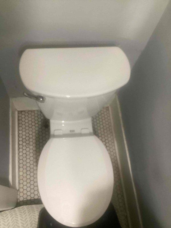 Successfully completed quoted toilet replacement in residential bathroom. Installed new standard white toilet with oval seat and chrome flush lever. Properly positioned unit on hexagonal mosaic tile flooring with appropriate sealing.