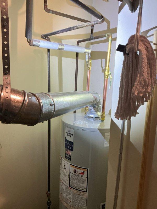 Performed complete installation of a new 40-gallon natural gas water heater in utility area. Connected copper, galvanized, and PVC piping with appropriate fittings and insulation. Verified all connections were secure with no leaks and confirmed proper venting for safe operation.