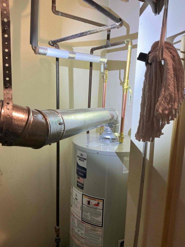 Performed complete installation of a new 40-gallon natural gas water heater in utility area. Connected copper, galvanized, and PVC piping with appropriate fittings and insulation. Verified all connections were secure with no leaks and confirmed proper venting for safe operation.