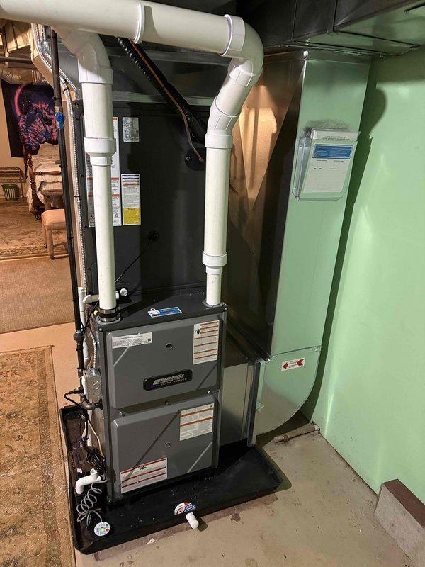 Successfully installed a complete HVAC system consisting of an Amana outdoor condenser unit on a concrete pad with proper line connections and a new indoor furnace with air handler in the basement. System includes dual PVC ventilation piping with appropriate ceiling connections, and all components were verified operational upon completion.