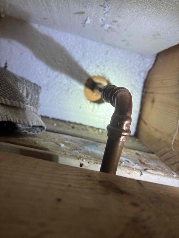 Identified and repaired a leaking outdoor spigot that was causing water infiltration into the home. Inspection revealed compromised copper pipe fittings at the 90-degree elbow connection, which were replaced along with the damaged brass valve assembly to restore proper function and prevent further water damage to the interior structure.