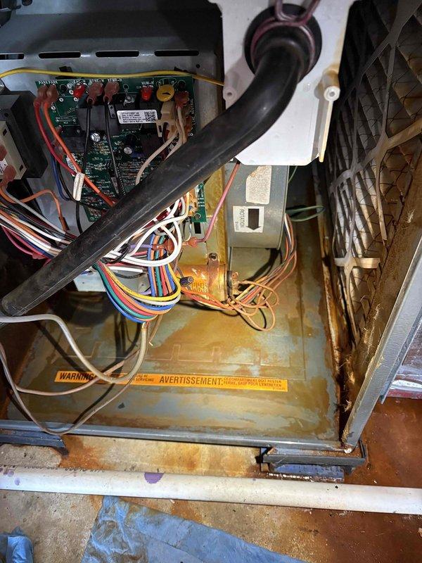 Performed annual heating maintenance on 9-year-old Goodman furnace. Observed significant rust and corrosion on cabinet floor indicating moisture issues. Customer is on service club but no humidifier was present as noted in service request.