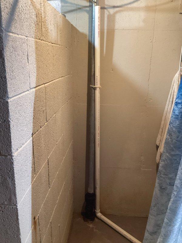 Inspected water heater with reported leak; identified deteriorated drain valve as source of water accumulation. Replaced faulty drain valve and verified proper operation with no further leakage observed. Recommended monitoring the 15-year-old unit for potential replacement in the near future due to age.