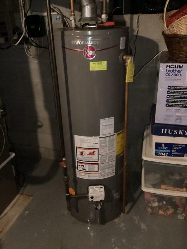 Responded to a leaking 10-year-old Rheem Performance water heater in a basement utility room. Inspected connections and piping system, identifying source of leak. Recommended replacement due to age and condition of unit.