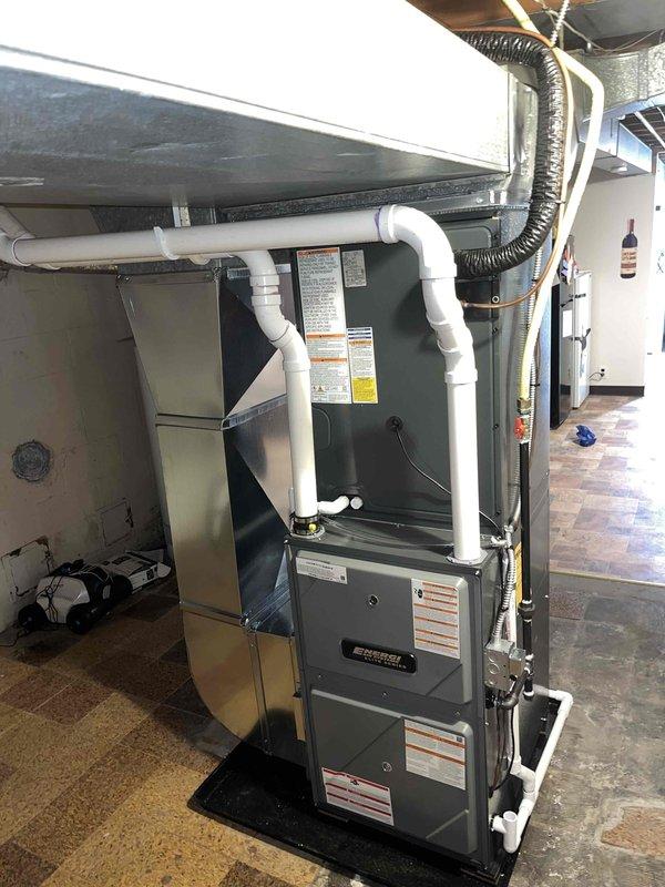 Successfully installed new furnace and air conditioning system in residential property, with proper connections to existing ductwork and electrical systems. New AC unit was properly mounted on concrete pad with appropriate refrigerant and power lines, while furnace installation included proper PVC ventilation components and condensate drainage setup.