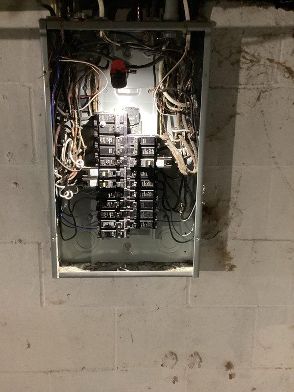 Completed electrical club inspection (ECI/CWOW) of main panel mounted on concrete block wall. Inspected interior components including circuit breakers, wiring connections, and overall condition of the installation. Panel was verified to be properly installed with "ELECTRICAL WIRING APPROVED" certification confirmed and documented with photos.