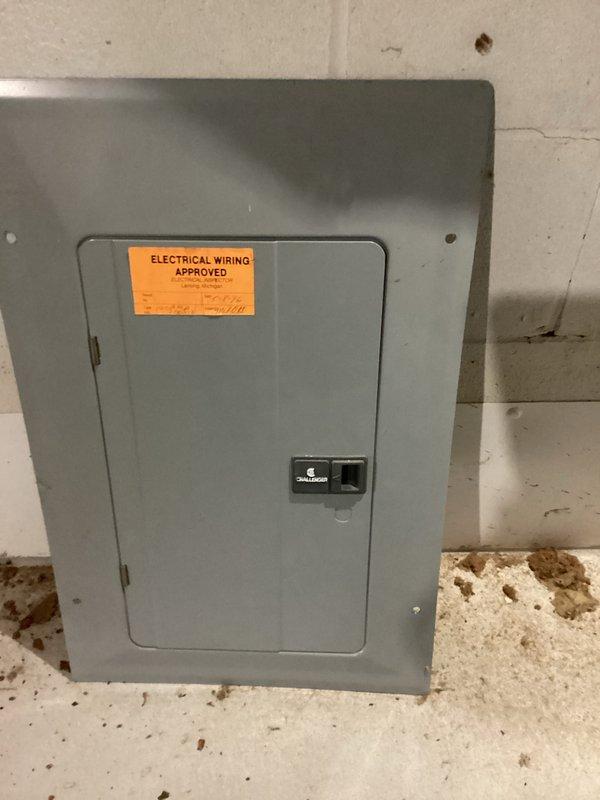 Completed electrical club inspection (ECI/CWOW) of main panel mounted on concrete block wall. Inspected interior components including circuit breakers, wiring connections, and overall condition of the installation. Panel was verified to be properly installed with "ELECTRICAL WIRING APPROVED" certification confirmed and documented with photos.
