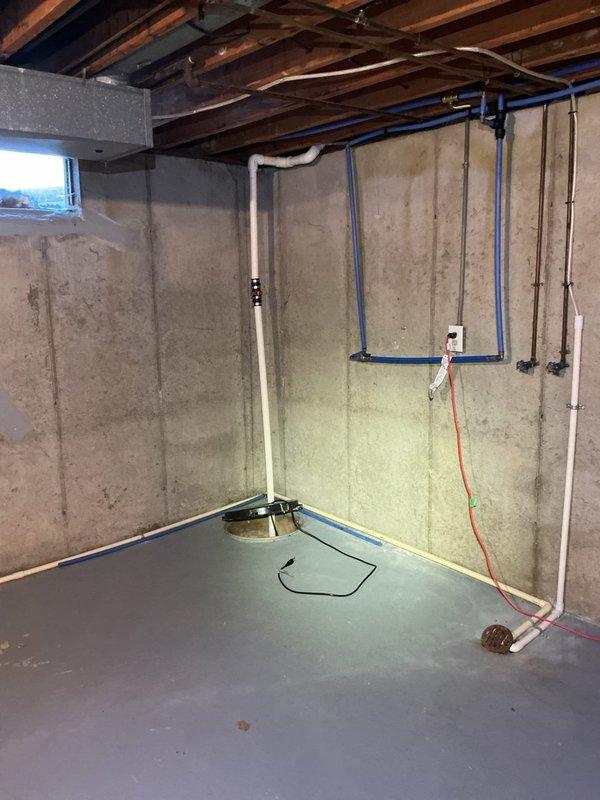 Completed an on-site assessment for a plumbing project estimate in an unfinished basement. Documented existing plumbing infrastructure including PVC drainage system connected to sump pump basin, blue PEX water supply lines, and copper piping. Client requested updated quote for plumbing work; comprehensive photos were taken of the installation area to facilitate accurate estimation.