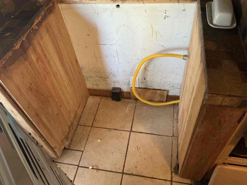 Successfully connected gas line to newly delivered range, ensuring proper installation of the yellow flexible gas hose with appropriate fittings and verifying secure connections for safe operation.