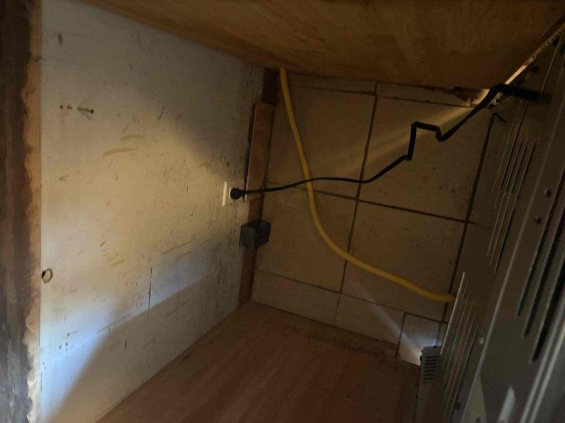 Successfully connected gas line to newly delivered range, ensuring proper installation of the yellow flexible gas hose with appropriate fittings and verifying secure connections for safe operation.