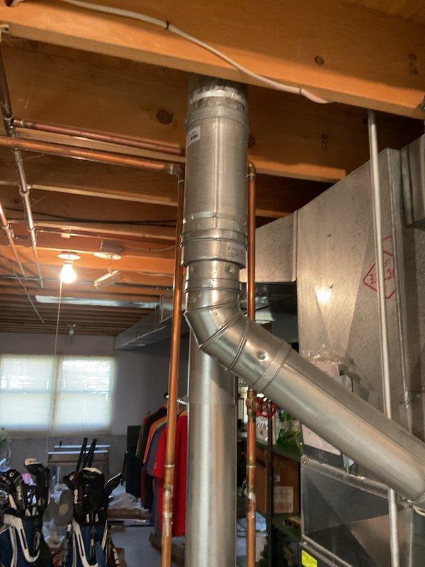 Performed annual furnace tune-up on 13-year-old energy-efficient system located in unfinished basement. Completed comprehensive inspection and maintenance services with no issues found; documented system condition with photos showing furnace, water heater, and associated ductwork in good working order.