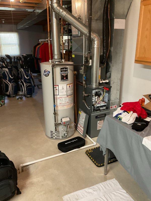 Performed annual furnace tune-up on 13-year-old energy-efficient system located in unfinished basement. Completed comprehensive inspection and maintenance services with no issues found; documented system condition with photos showing furnace, water heater, and associated ductwork in good working order.