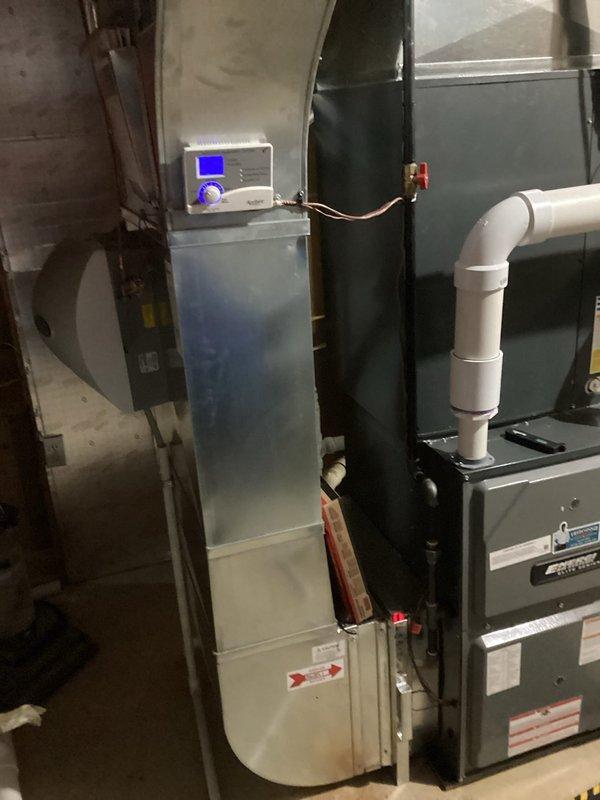 Completed annual heating maintenance on a 6-year-old Energi furnace (warranty valid until 4/2029) with connected humidifier. System inspection revealed properly functioning components with all connections secure. Digital control panel operating normally with no error codes present. Cleaned and inspected furnace and humidification system as part of club membership service.