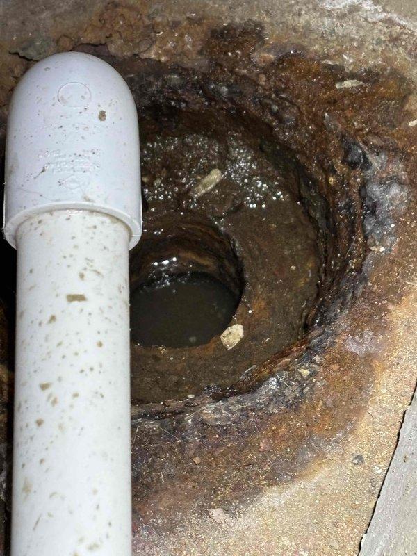 Performed annual heating tune-up on EnergiAir furnace (Model WT 07-2035) as scheduled complimentary maintenance. During inspection, documented significant drainage system issues including severe corrosion around drain opening and deterioration of surrounding materials. Photographic evidence shows advanced oxidation, mineral buildup, and possible mold formation at drain connection point where PVC piping enters floor drain.