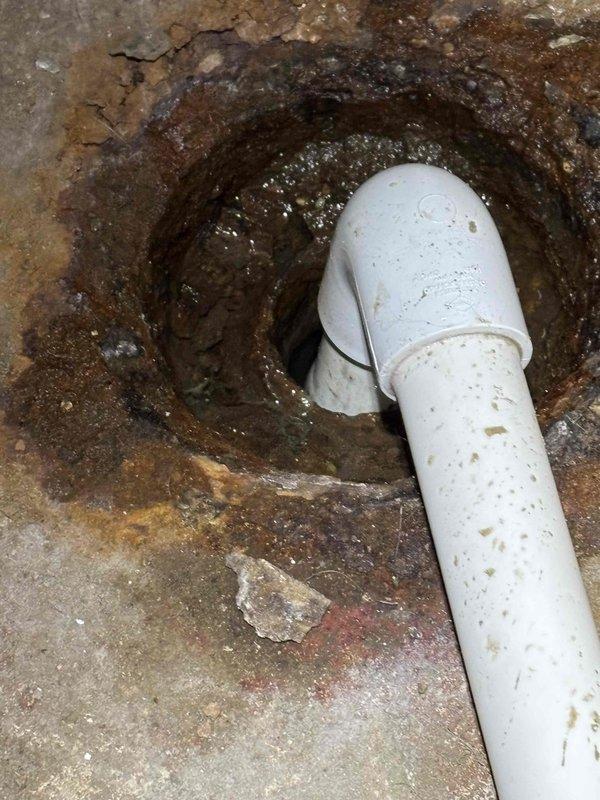 Performed annual heating tune-up on EnergiAir furnace (Model WT 07-2035) as scheduled complimentary maintenance. During inspection, documented significant drainage system issues including severe corrosion around drain opening and deterioration of surrounding materials. Photographic evidence shows advanced oxidation, mineral buildup, and possible mold formation at drain connection point where PVC piping enters floor drain.