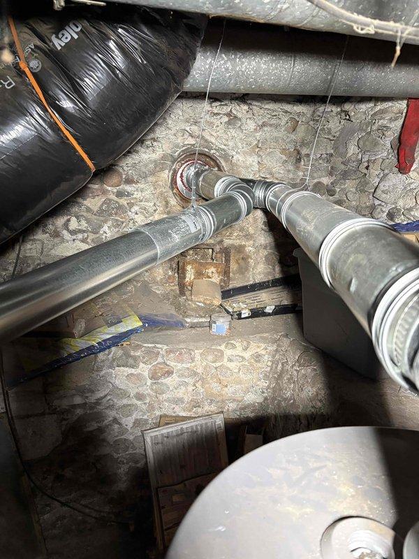 Successfully installed new Carrier furnace system in basement utility area, properly connecting unit to existing circular metal ductwork with appropriate elbow joints. Completed all necessary connections and verified proper operation of the system prior to finalizing installation paperwork.