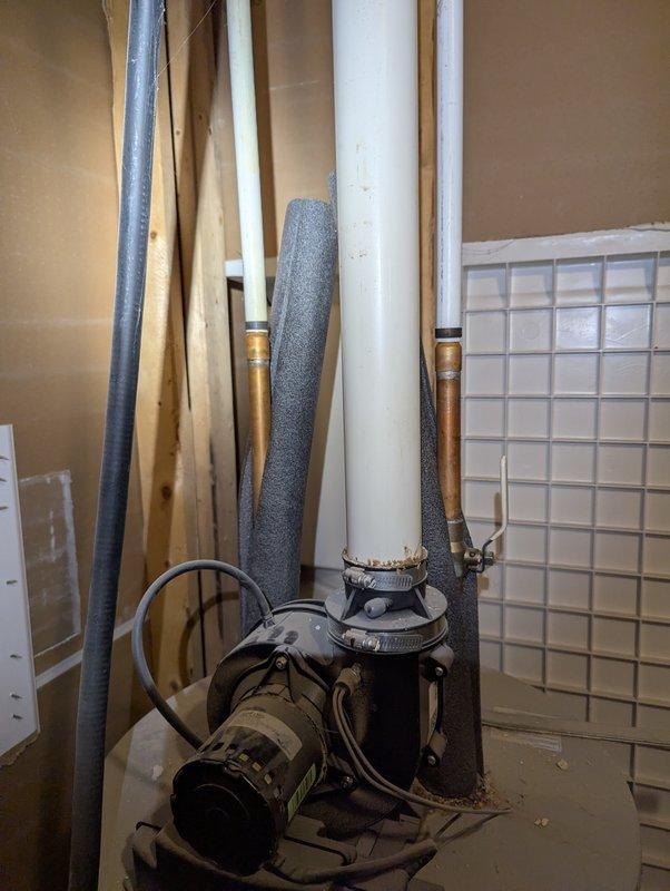 Responded to service call for 10-year-old Lochinvar water heater with ignition failure and flashing flammable vapor code on control unit. Inspected plumbing infrastructure and PVC drainage components in utility area. Documented condition with photos showing water heating system and associated piping.