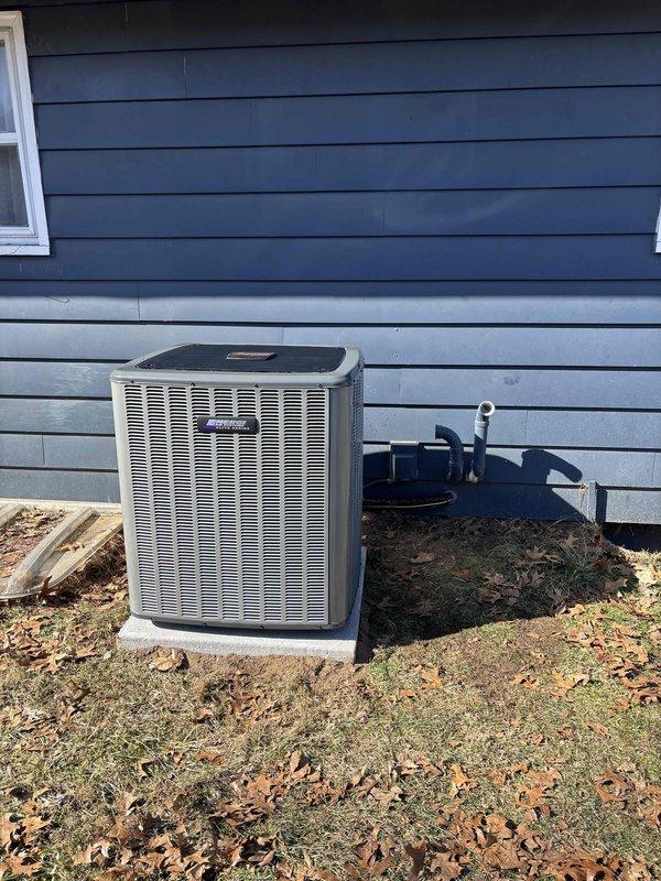 Completed installation of new Amana HVAC system including indoor furnace unit with PVC venting in utility area and outdoor AC condensing unit mounted on concrete pad. System properly connected to existing ductwork with all mechanical and electrical connections secured and tested for operation.
