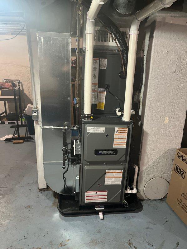 Completed installation of new Bradford White water heater and Energi furnace with associated ductwork in basement utility area. Systems were properly connected with appropriate copper supply lines, PVC venting, and drain pan placement. All components were tested and confirmed to be in normal working condition with no leaks or abnormalities.