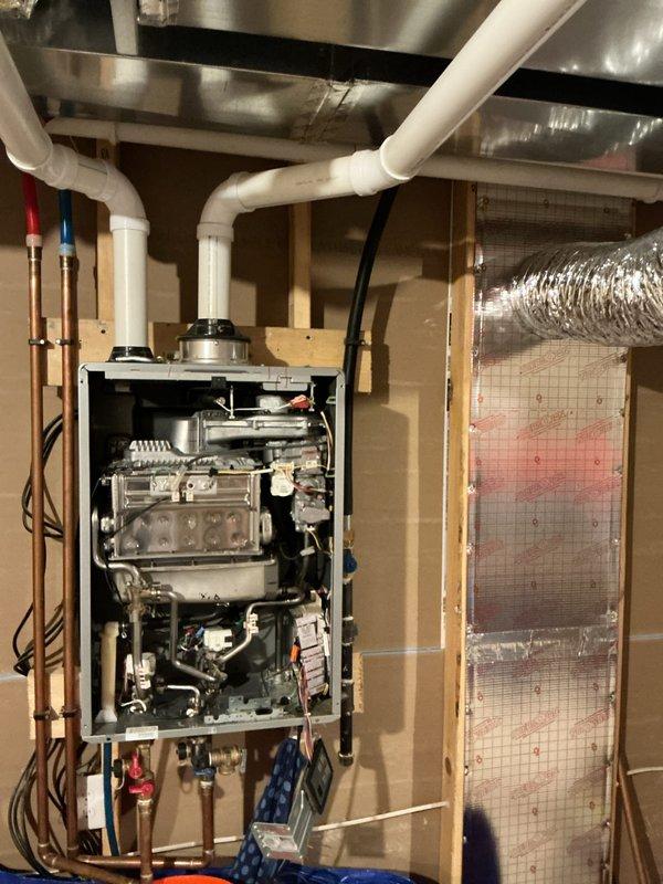 Performed a quoted repair on customer's tankless water heater system. Accessed unit in basement utility area, removed front panel for internal component inspection, and serviced the system connecting to both PVC venting and copper water lines. Successfully completed necessary repairs to restore proper functionality.