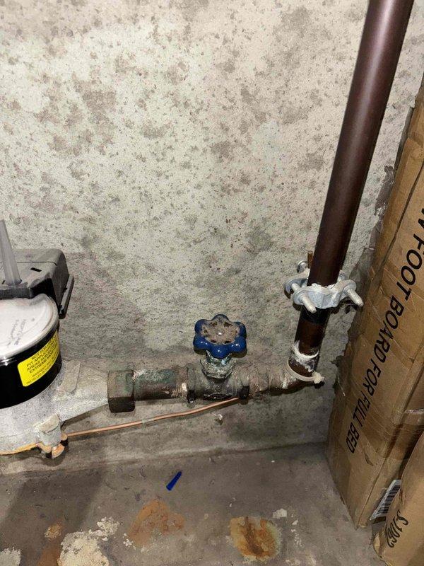 Successfully installed a new shut-off valve in the basement near the sump pump location. Completed copper pipe connections with appropriate fittings and secured the vertical pipe with a metal bracket against the concrete wall. All connections were tested for proper functionality and no leaks were detected.