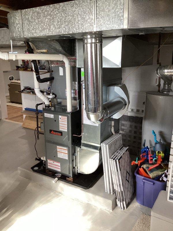 Successfully completed installation of an Amana furnace system in the basement utility area, including proper connection of metal ductwork, PVC condensate lines, and vertical vent piping. System was tested for proper operation and all safety protocols were followed per manufacturer specifications.