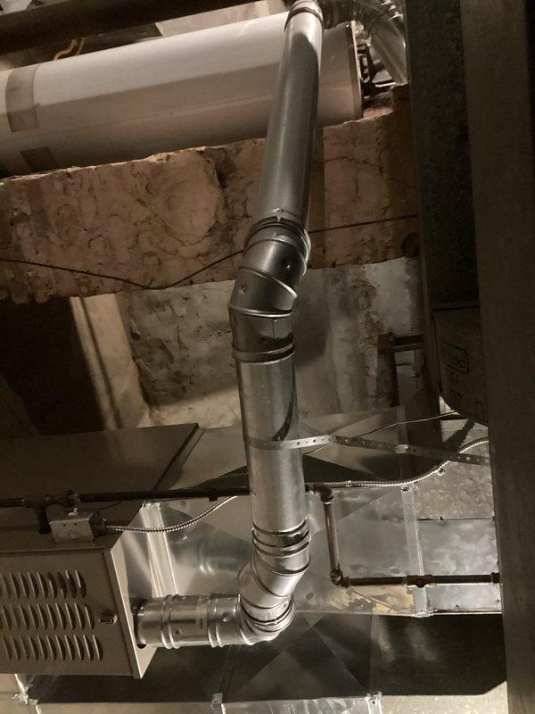 Completed CORR inspection correction on newly installed Carrier furnace (CM: 2026). Verified proper venting alignment and pitch of flue pipe using spirit level, ensuring exhaust gases flow correctly. System is operating properly and now complies with inspection requirements.