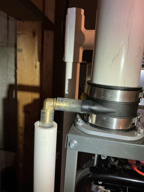 Completed annual heating maintenance on EnergiAir WT 12-2033 furnace (manufactured 2011). Inspected condensate drain system and verified proper installation of PVC piping and drain connections. Photographic documentation taken of the furnace components and drain assembly showing system in functional condition with no visible leaks or damage.