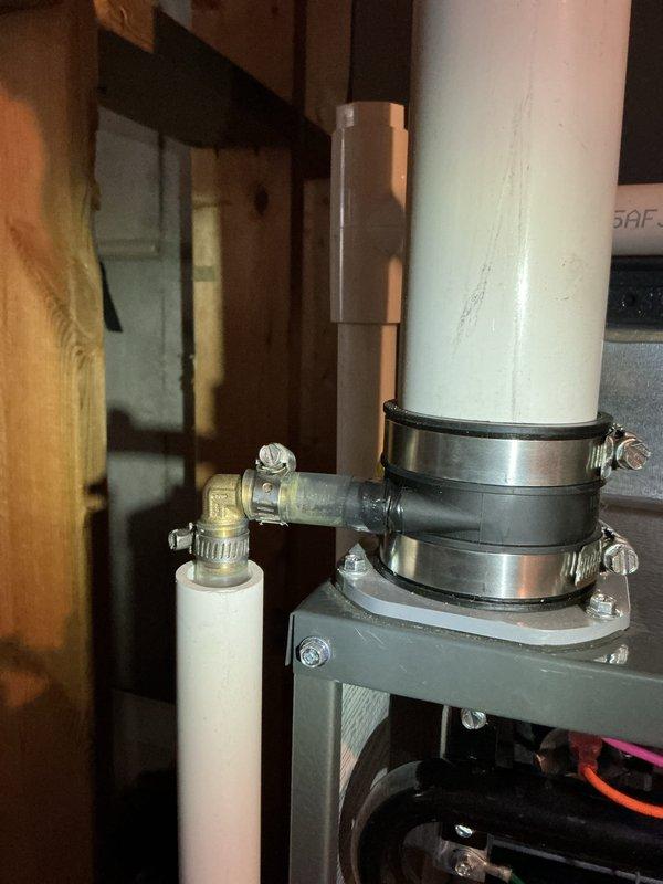 Completed annual heating maintenance on EnergiAir WT 12-2033 furnace (manufactured 2011). Inspected condensate drain system and verified proper installation of PVC piping and drain connections. Photographic documentation taken of the furnace components and drain assembly showing system in functional condition with no visible leaks or damage.