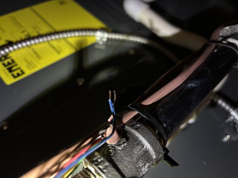Completed annual heating maintenance on furnace with humidifier. Observed damaged wiring insulation with exposed copper/blue wires near a metal fitting and documented condition with photos. System appears operational but wiring should be monitored for further deterioration.
