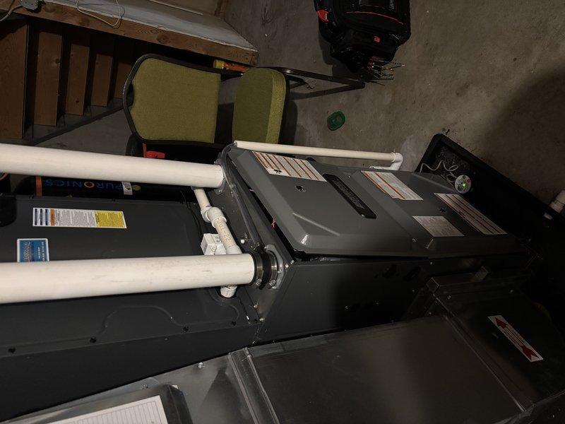 Completed annual heating maintenance on furnace with humidifier. Observed damaged wiring insulation with exposed copper/blue wires near a metal fitting and documented condition with photos. System appears operational but wiring should be monitored for further deterioration.